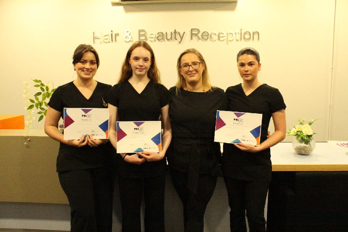 Beauty students with their certificates for winning the intercampus skills competition